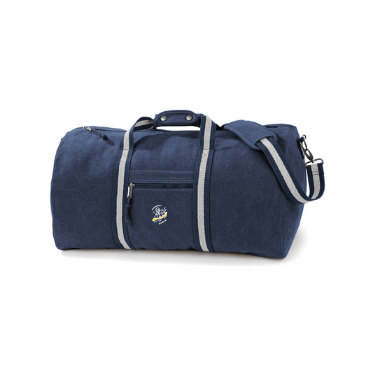 A travel bag or weekend tote featuring an illustration of a snowboarder cruising down powdery snow